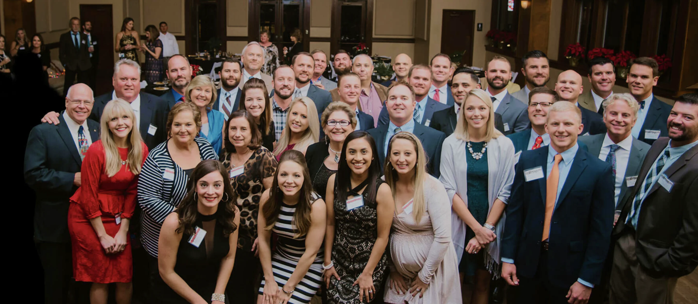 A group photo of all the team members listed below inside a convention center.